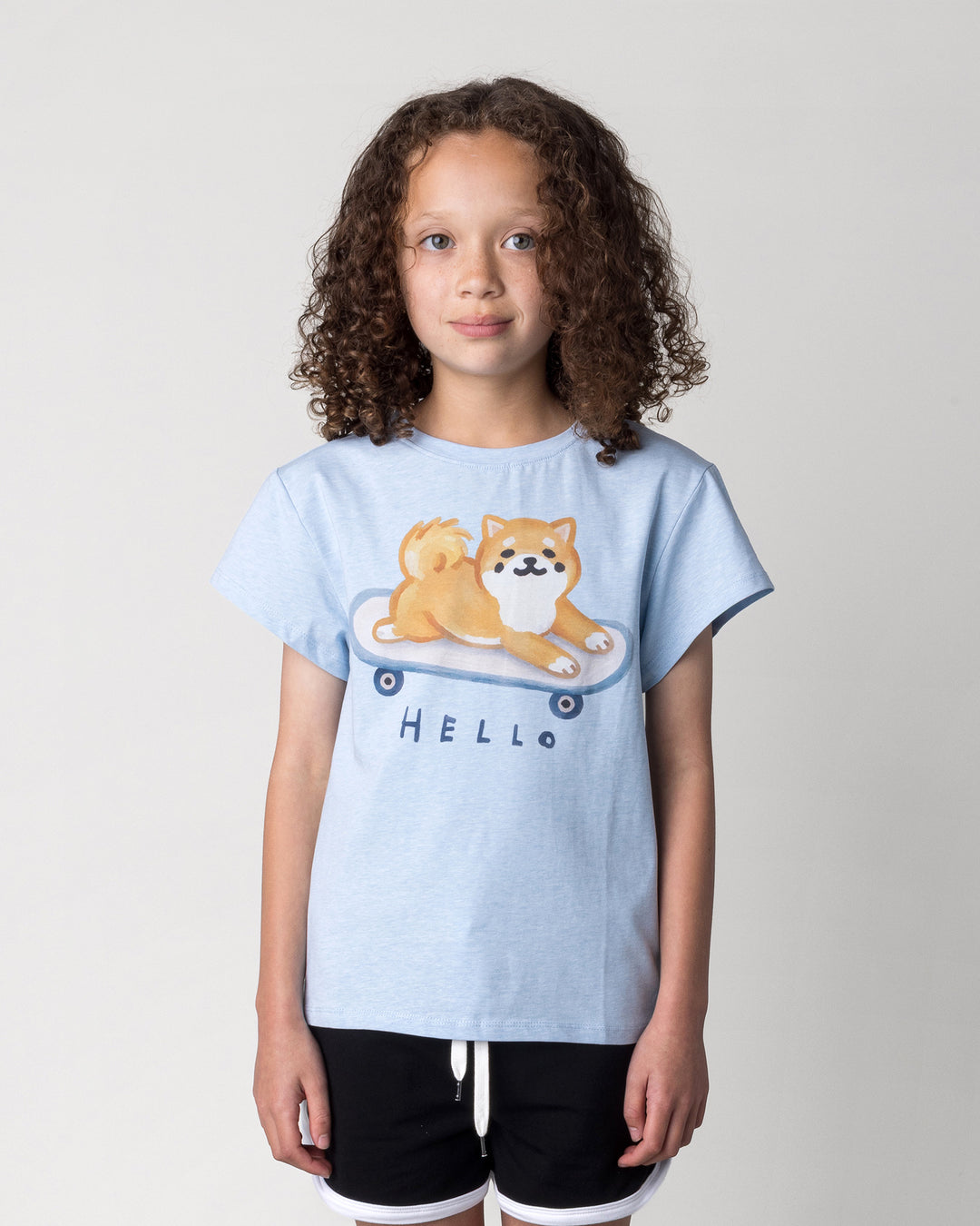 Close up of the Skate Puppy Tee in light blue marle on a kid, front view