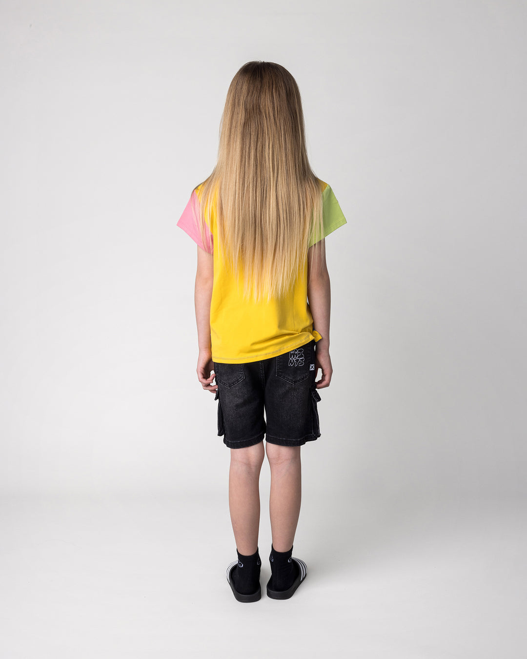 Kid wearing the Stay Cool Tee in multi, back view