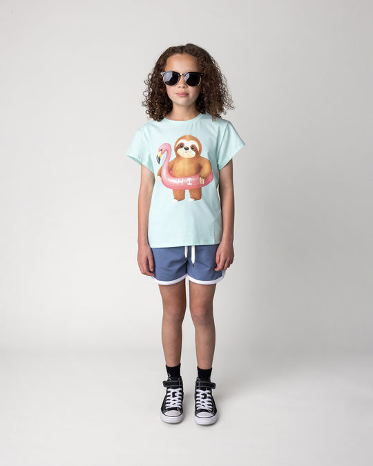 Kid wearing the Swimming Sloth Tee in mint marle with the Sprint Short in cornflower and white, front view