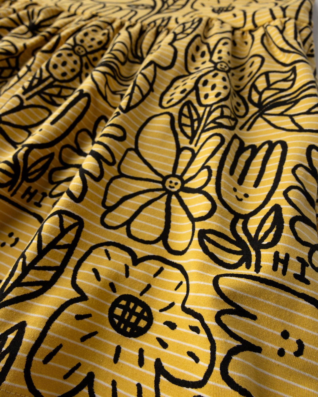 Close up detail of the Big Flowers Dress in mustard stripe