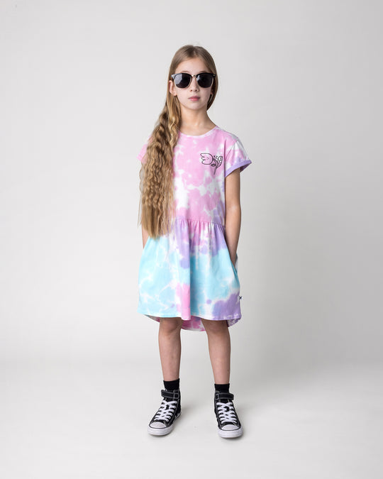 Kid wearing the Pocket Flower Dress in tie dye, front view
