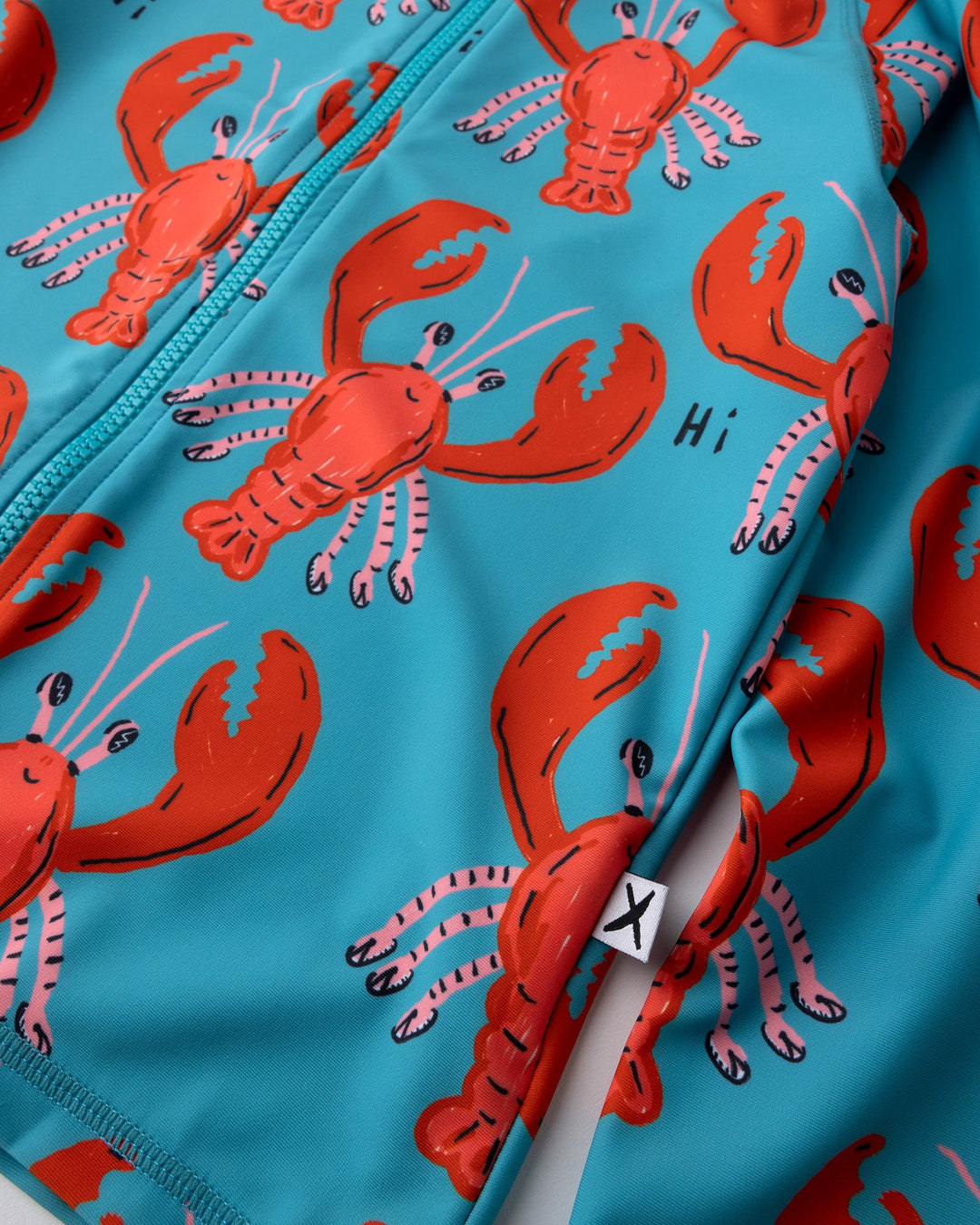 Close up of the Vacay Crayfish Rashie print in teal