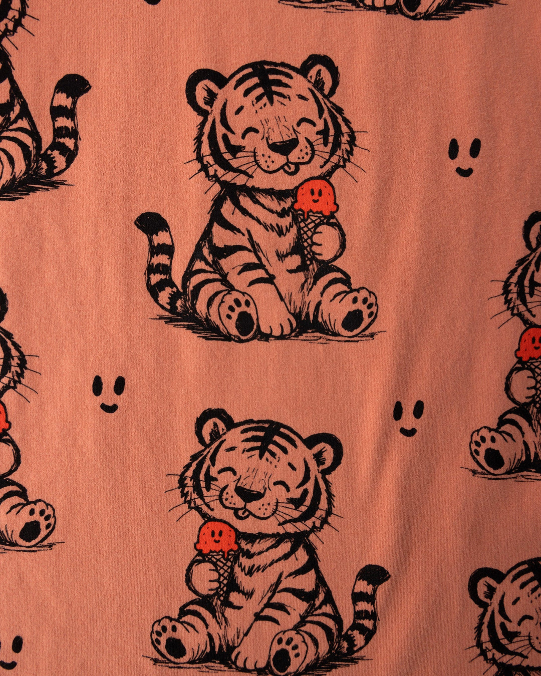 Close up of the Happy Tiger Tee print in apricot