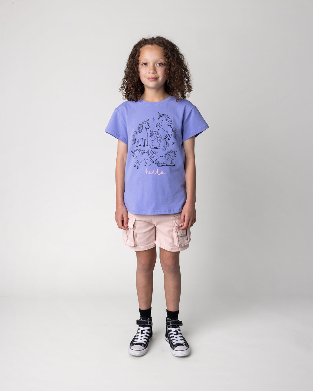 Kid wearing the Hello Unicorns Tee in purple, front view