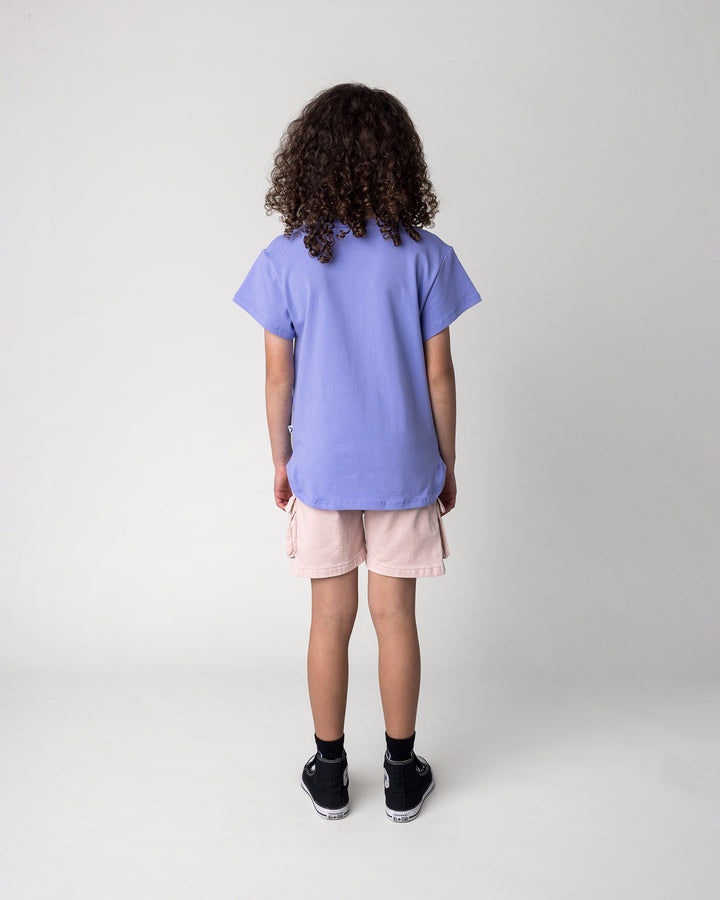Kid wearing the Hello Unicorns Tee in purple, back view