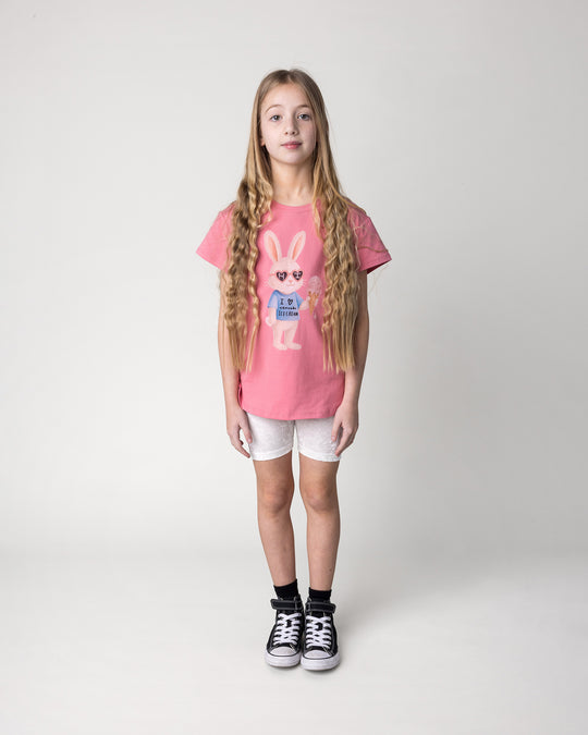 Kid wearing the Icecream Bunny Tee in candy with the Velvet Bike Pant in cream, front view