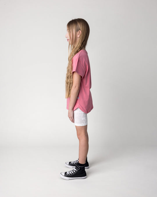 Kid wearing the Icecream Bunny Tee in candy with the Velvet Bike Pant in cream, side view