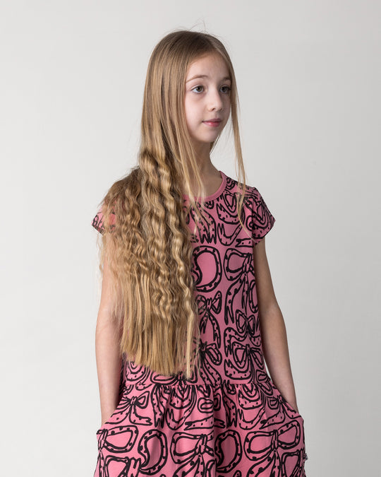 Close up of the Big Bows Dress in candy on a kid, front view