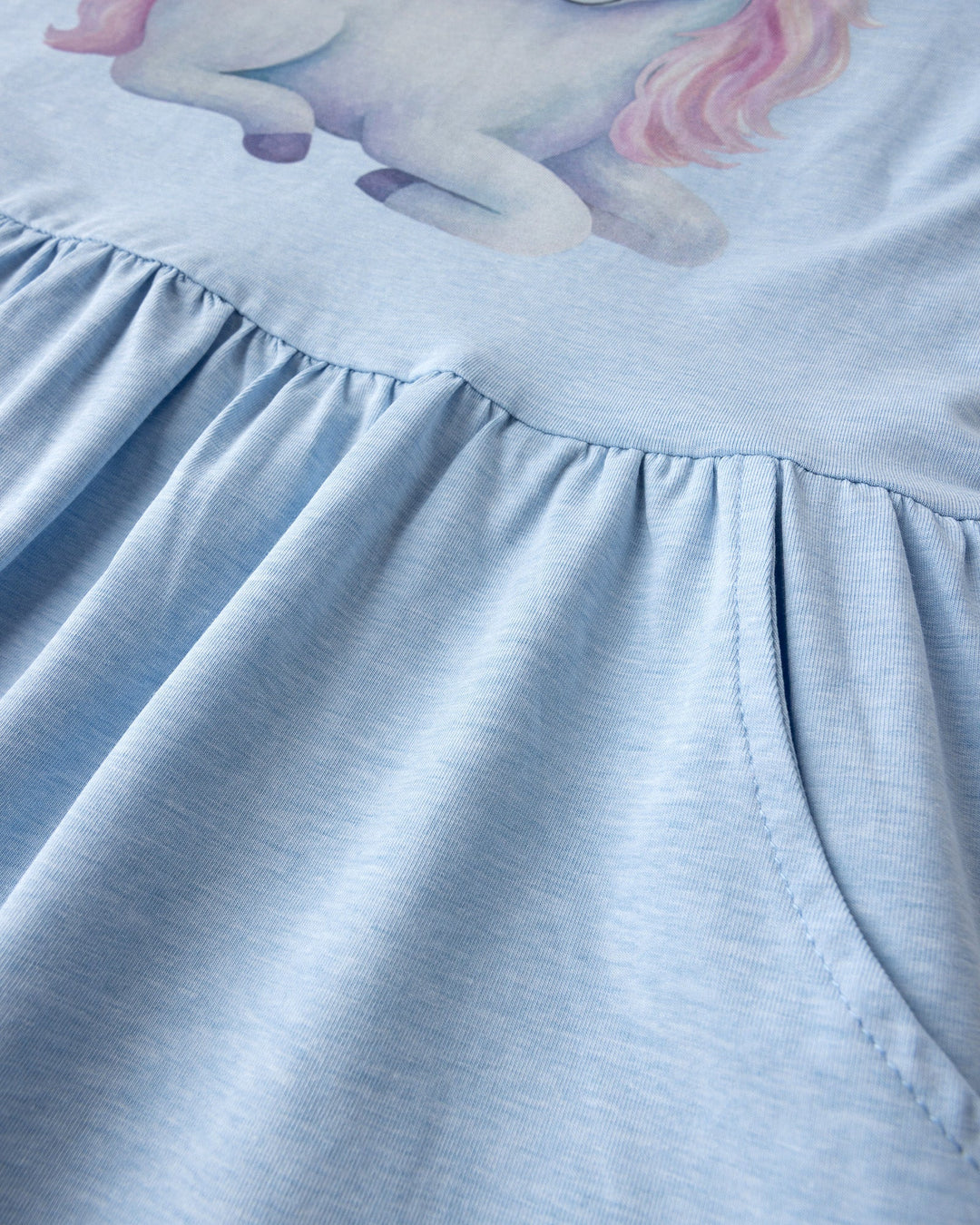Close up detail of the Daydreaming Unicorn Dress in light blue marle