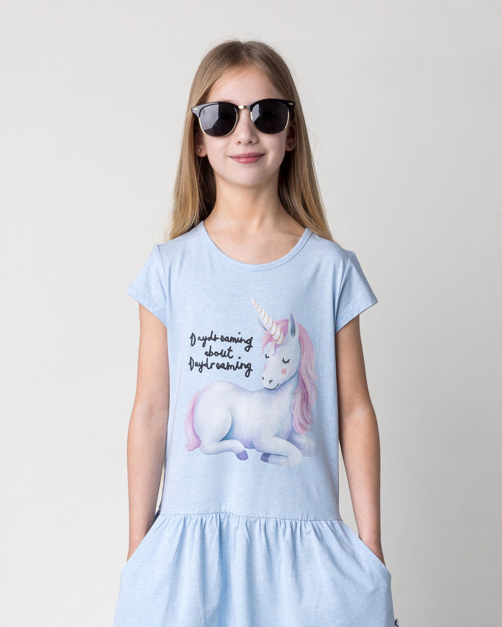 Close up of the Daydreaming Unicorn Dress in light blue marle on a kid, front view