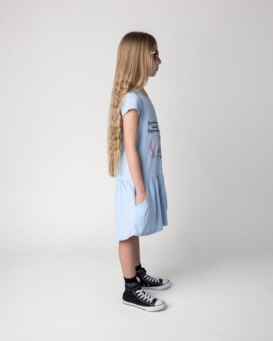 Kid wearing the Daydreaming Unicorn Dress in light blue marle, side view