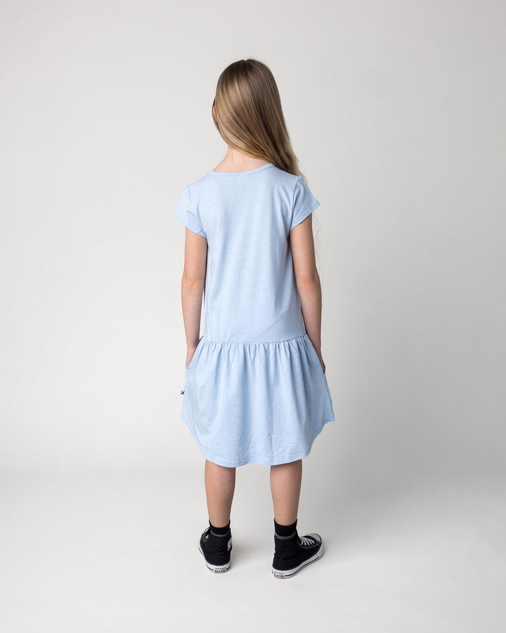 Kid wearing the Daydreaming Unicorn Dress in light blue marle, back view