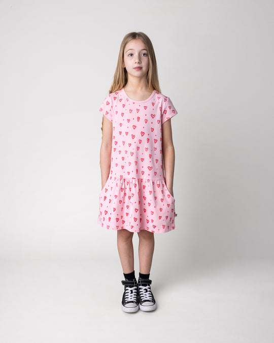 Kid wearing the Hearts Dress in pink, front view