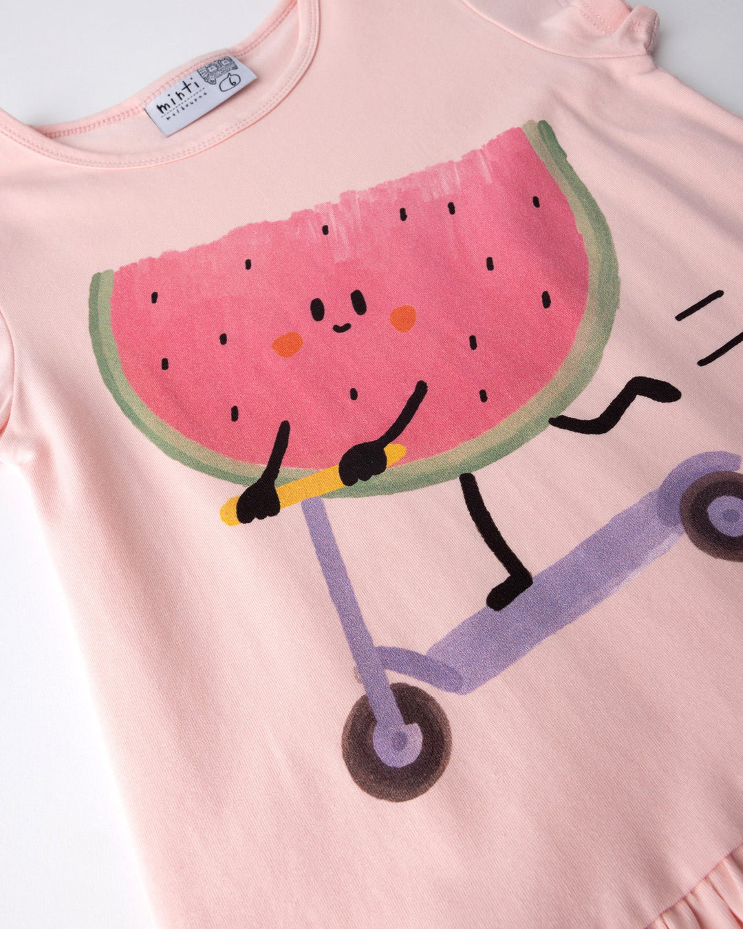 Close up of the Scooting Watermelon Dress print in light pink