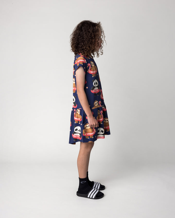 Kid wearing the Swimming Buddies Dress in midnight, side view