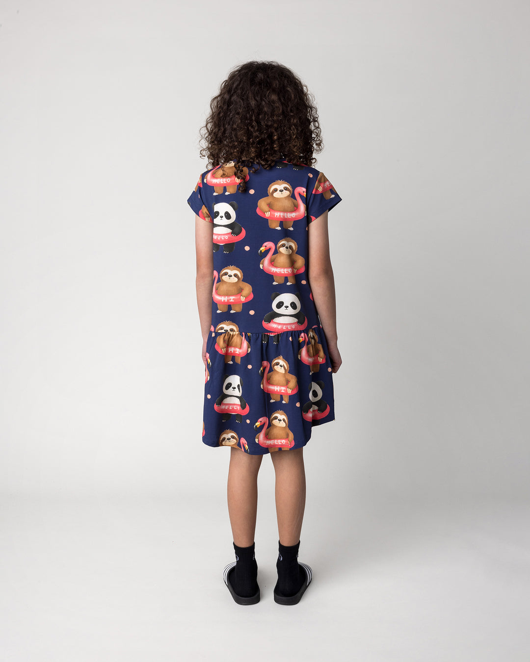 Kid wearing the Swimming Buddies Dress in midnight, back view