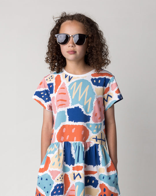 Close up of the Cool Shapes Dress in white on a kid, front view