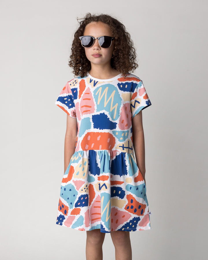 Close up of the Cool Shapes Dress in white on a kid, front view