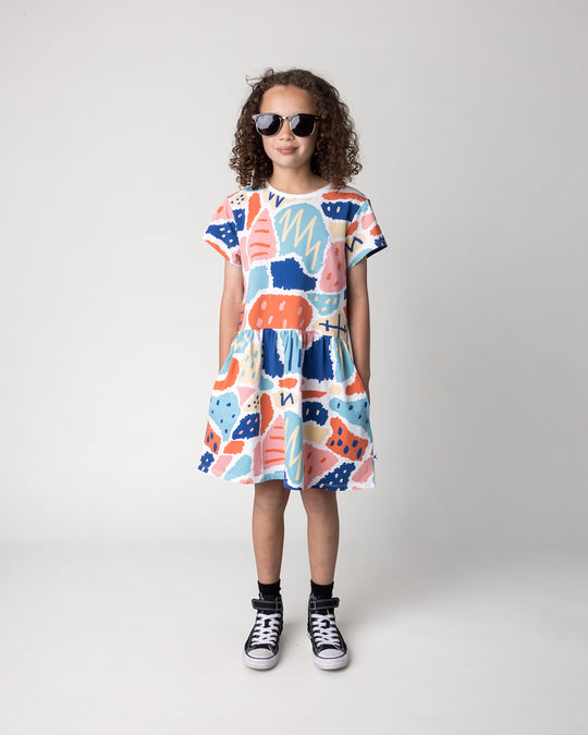 Kid wearing the Cool Shapes Dress in white, front view