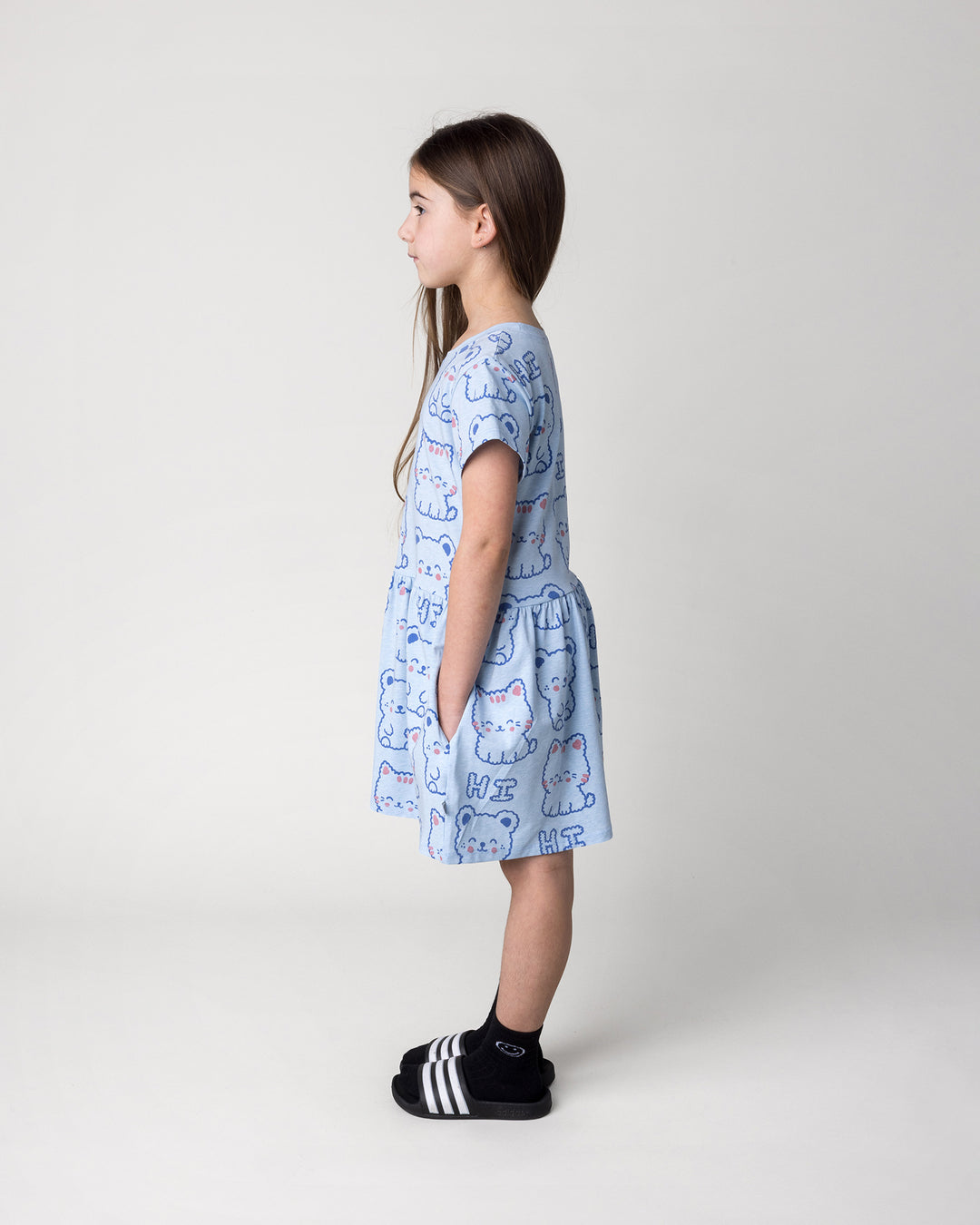 Kid wearing the Hi Cat Bear Dress in light blue marle, side view