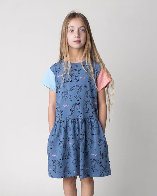 Close up of the Hello Unicorns Dress in mid blue, light blue and pink on a kid, front view