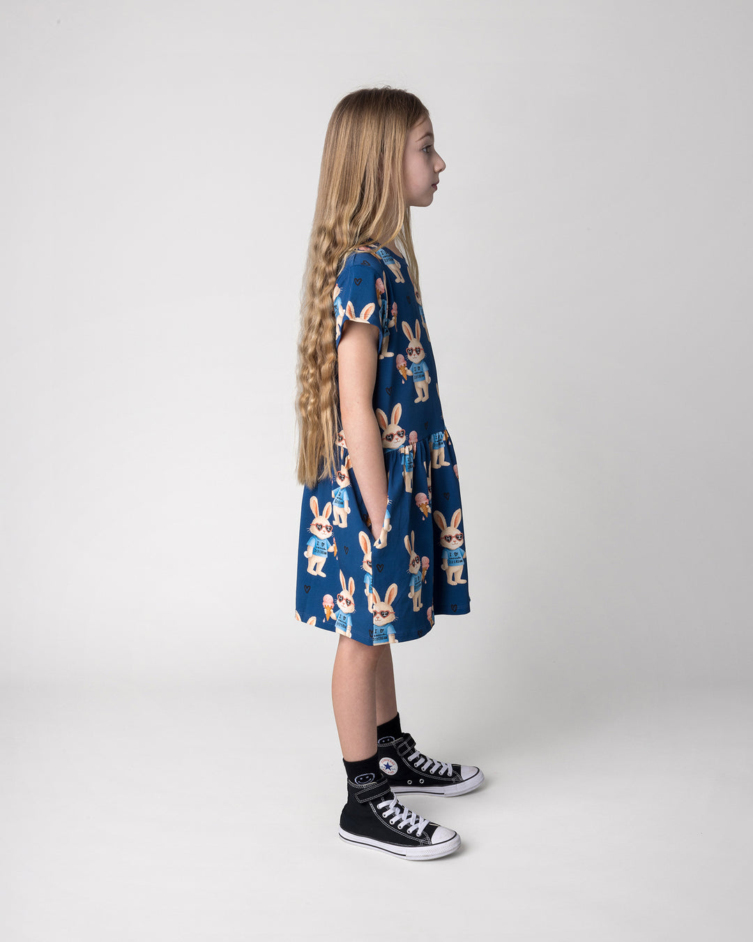 Kid wearing the Icecream Bunny Dress in blue, side view