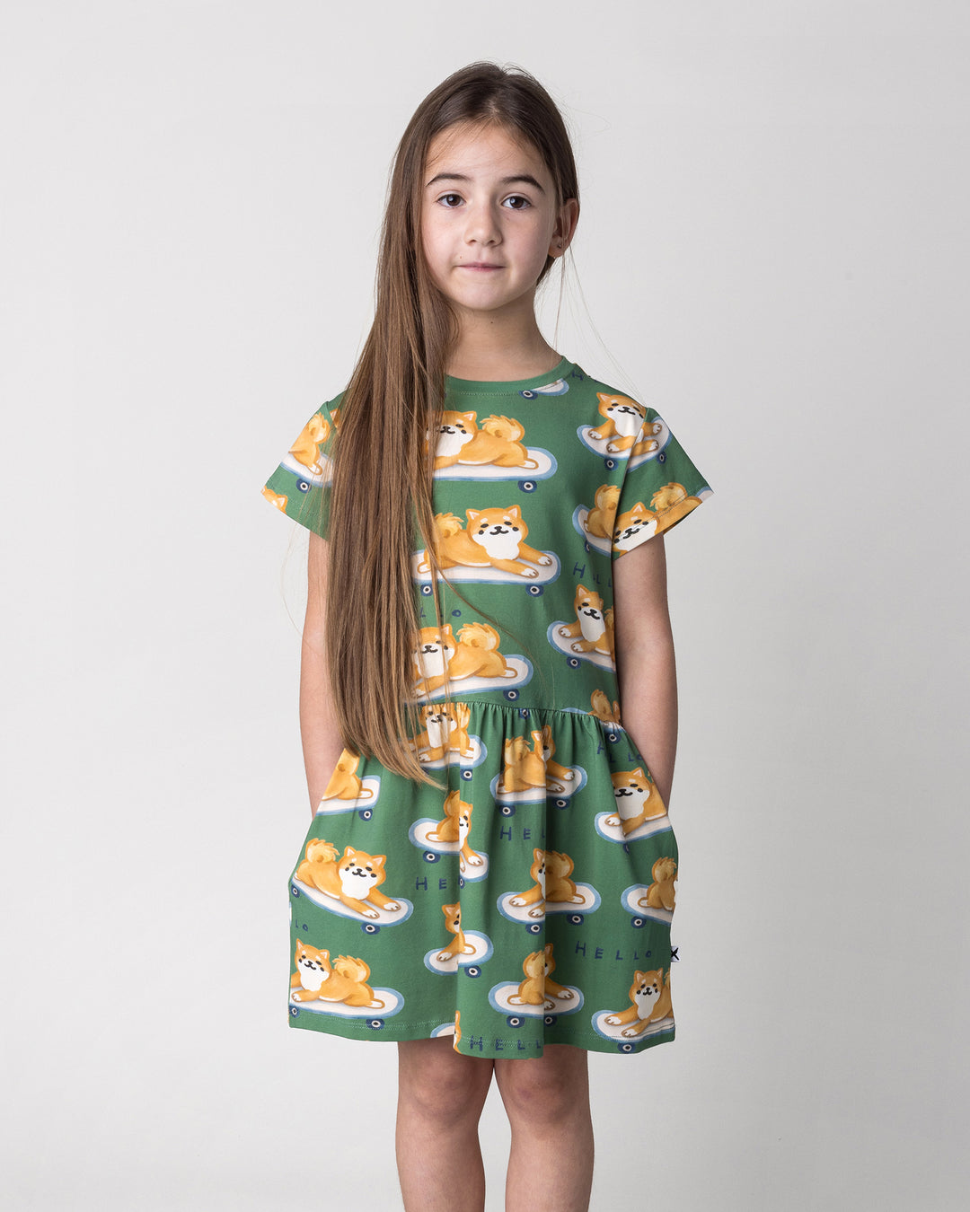 Close up of the Skate Puppy Dress in turf on a kid, front view