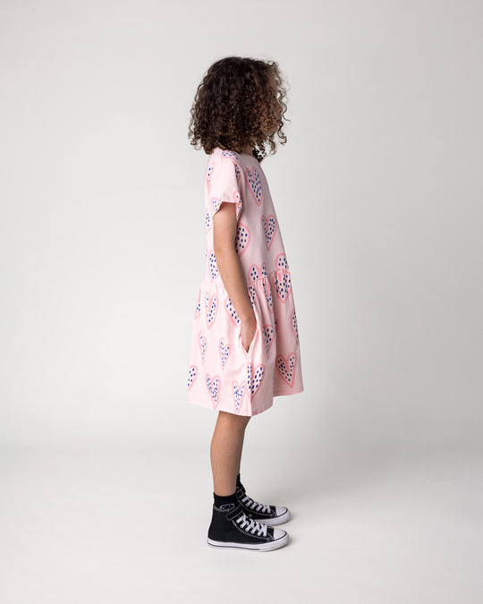 Kid wearing the Speckle Heart Dress in pink, side view