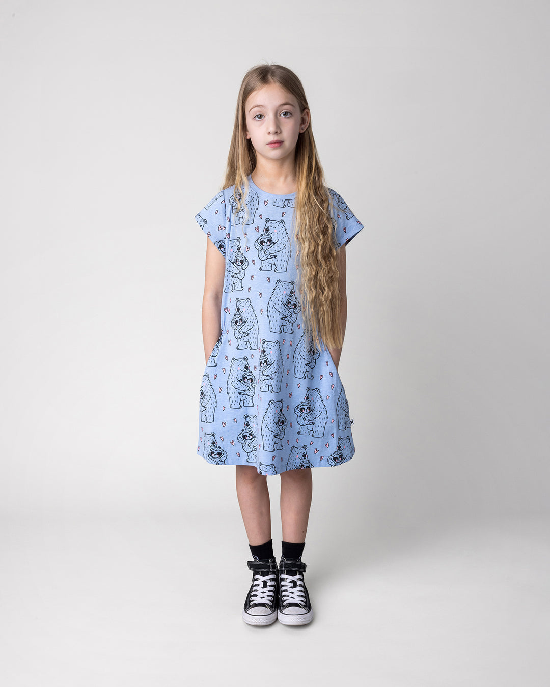 Kid wearing the Bear Hug Dress in blue marle, front view