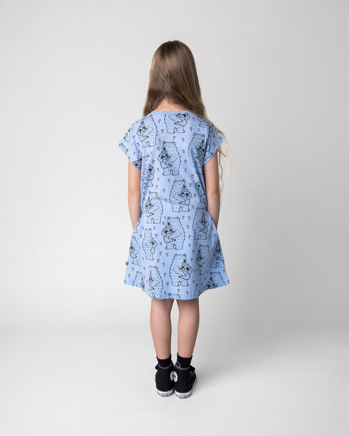 Kid wearing the Bear Hug Dress in blue marle, back view