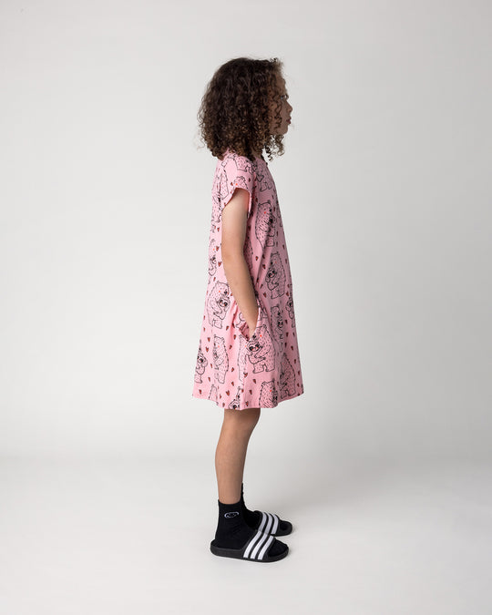 Kid wearing the Bear Hug Dress in pink, side view