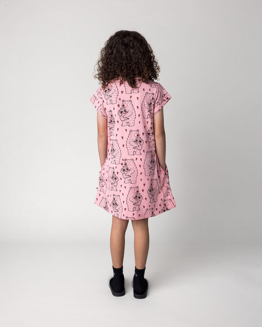 Kid wearing the Bear Hug Dress in pink, back view