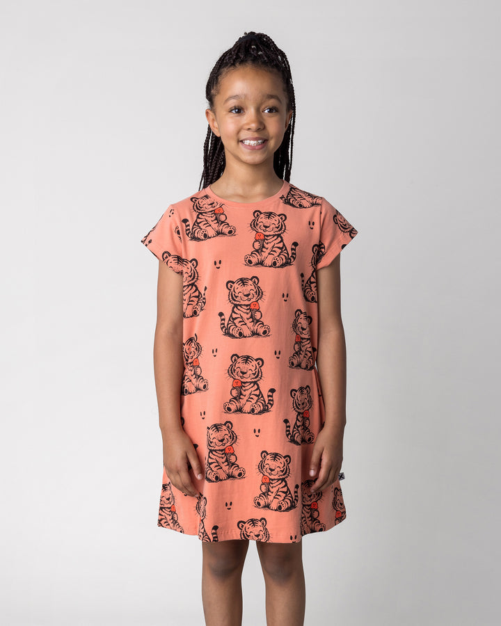 Close up of the Happy Tiger Dress in apricot on a kid, front view