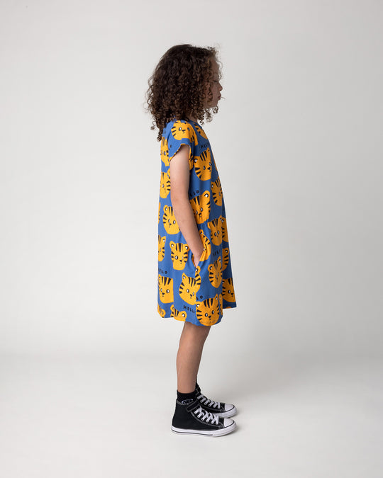 Kid wearing the Hello Tiger Dress in blue, side view