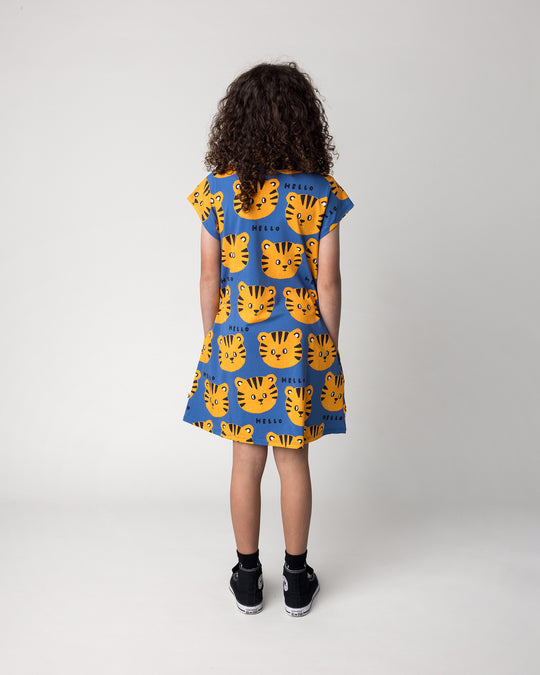 Kid wearing the Hello Tiger Dress in blue, back view