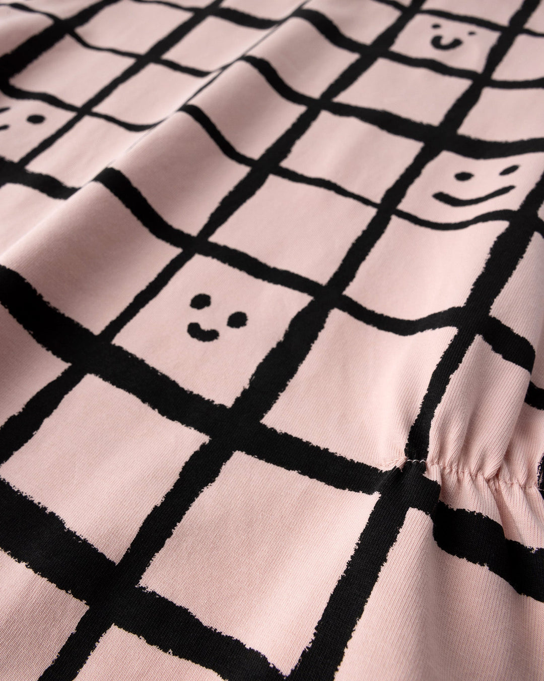 Close up of the Happy Squares Dress print in dusty pink