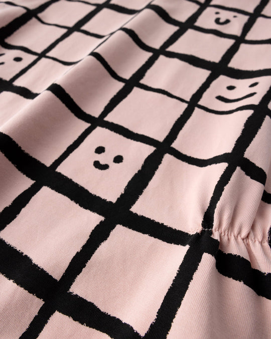 Close up of the Happy Squares Dress print in dusty pink