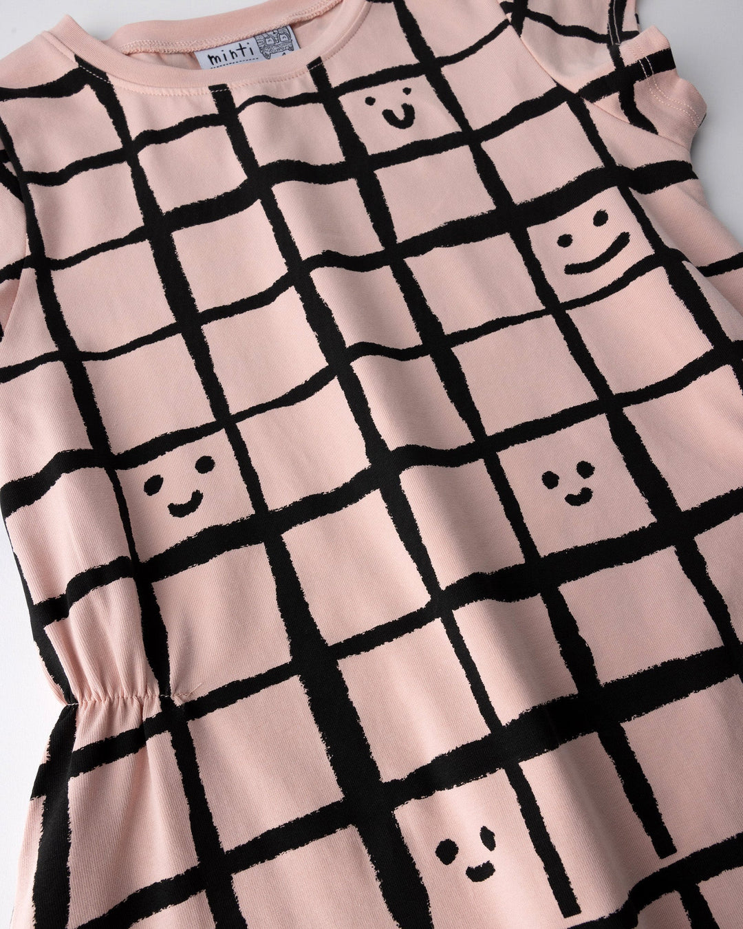 Close up of the Happy Squares Dress print in dusty pink