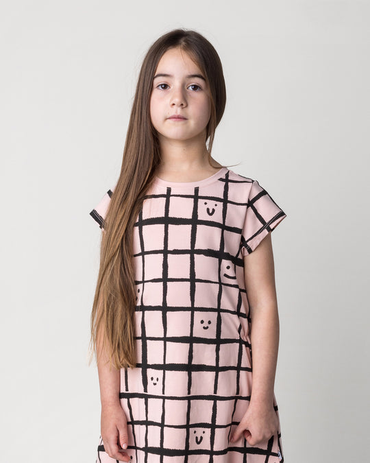 Close up of the Happy Squares Dress in dusty pink on a kid, front view