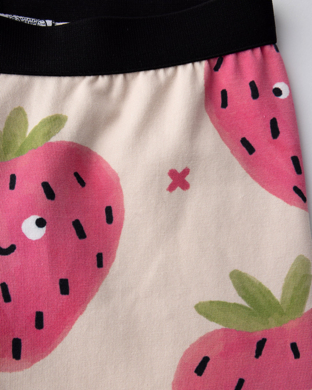 Close up of the Happy Strawberry Bike Pant print in cream