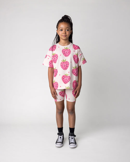 Kid wearing the Happy Strawberry Bike Pant in cream with the Happy Strawberry Tee in cream, front view