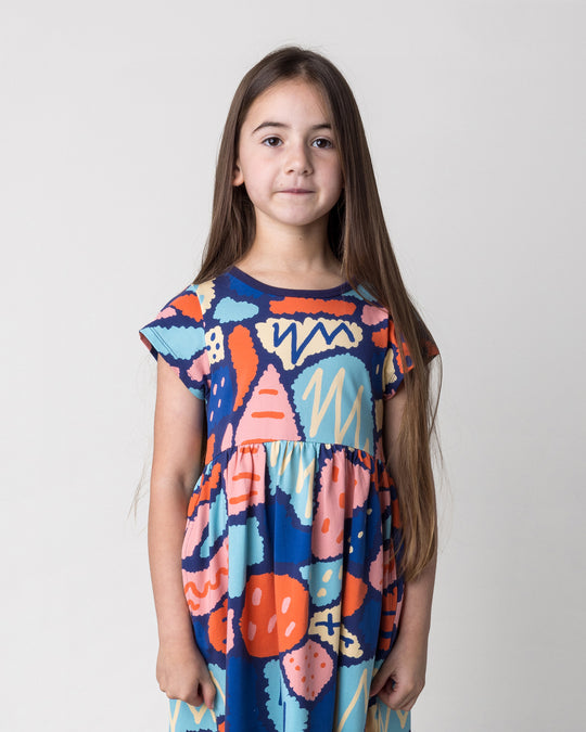 Close up of the Cool Shapes Dress in dark blue on a kid, front view