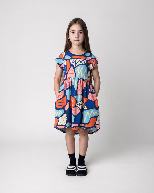 Kid wearing the Cool Shapes Dress in dark blue, front view