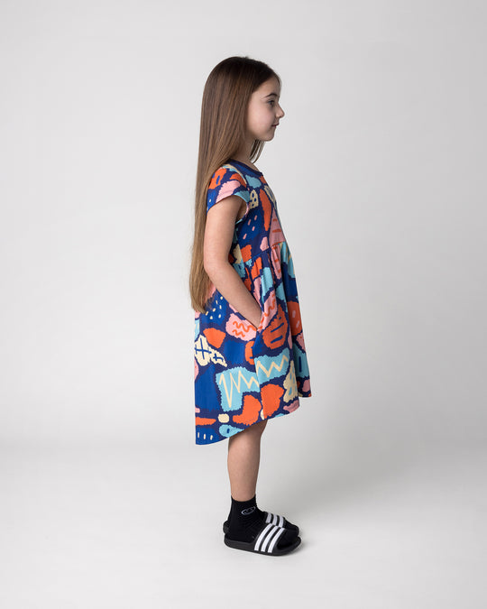 Kid wearing the Cool Shapes Dress in dark blue, side view