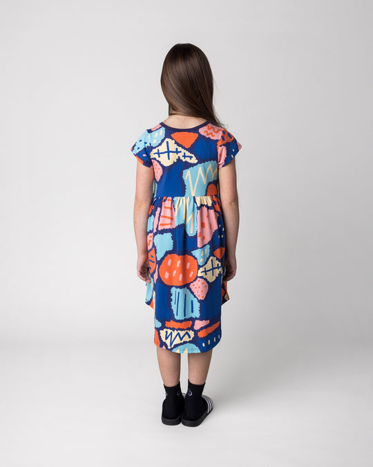 Kid wearing the Cool Shapes Dress in dark blue, back view