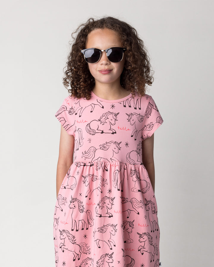 Close up of the Hello Unicorns Dress in pink on a kid, front view