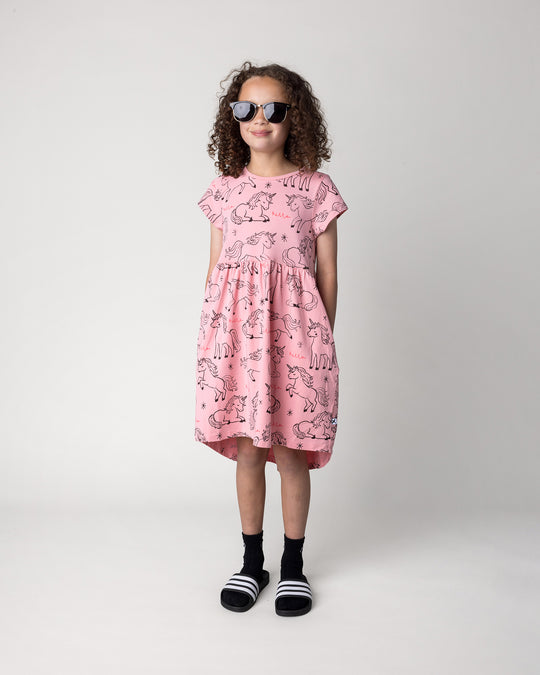 Kid wearing the Hello Unicorns Dress in pink, front view