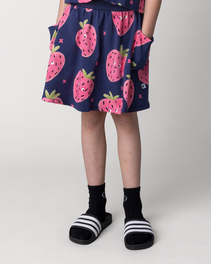 Kid wearing the Happy Strawberry Skirt in turquoise, front view close up