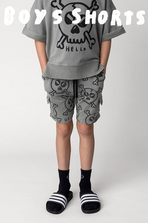 Shop boys shorts at Minti, kid wearing the Hello Skull Short in grey wash