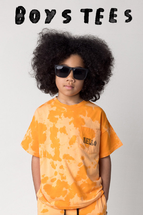 Shop boys tees at Minti, kid wearing the Splatter Tee in orange